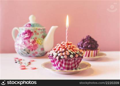 muffins with illuminated candle birthday