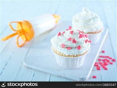 muffins with white cream on a table
