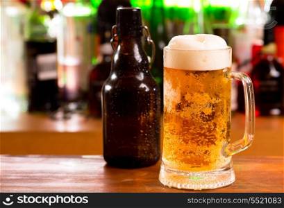 mug of beer and bottle in a bar