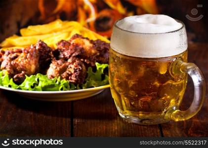 mug of beer and grilled chicken wings