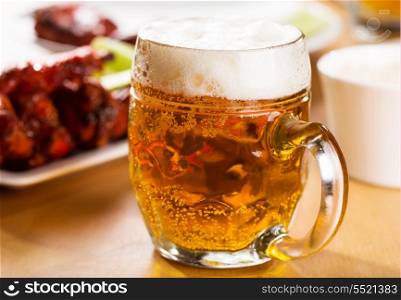 mug of beer with chicken wings