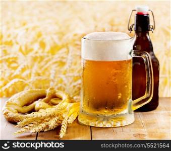 mug of beer with wheat ears on wooden table