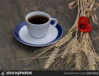 mug of black coffee wheaten colossuses and flower