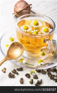 mug of herb tea with chamomile flowers. cup of herbal healthy tea with chamomile flowers