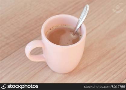 Mug of hot coffee with cream.