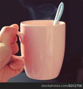 Mug of hot coffee with cream.