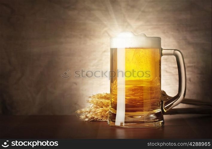 Mug of lager beer with a solar flare on burlap background