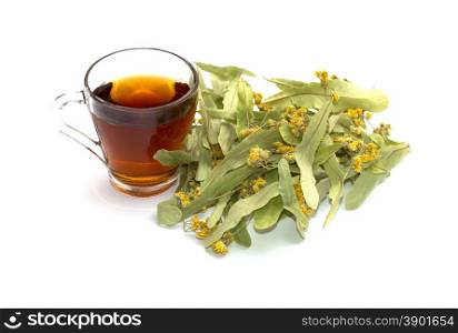 mug of lime tea and heap of a collected linden on a white background