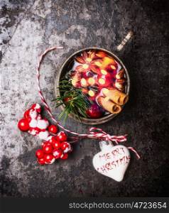 Mug of mulled wine with bokeh and Christmas decorations, top view