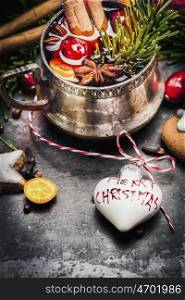 Mug of mulled wine with spices , cookies and Christmas decoration