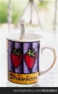 Mug outdoor over a table, vertical image