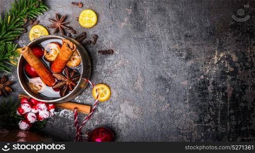 Mug with mulled wine and Christmas decoration on dark background, top view, place for text