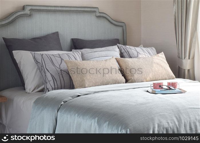 Mugs and book are on the romantic bedding style