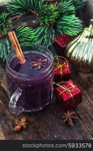 Mulled wine and Christmas tree.. A glass of wine with the cinnamon stick and star anise amid the branches of the spruce.
