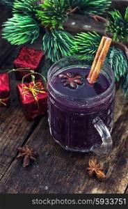 Mulled wine and Christmas tree.. A glass of wine with the cinnamon stick and star anise amid the branches of the spruce.