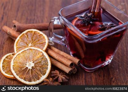 Mulled wine and spices on wooden table. Mulled wine