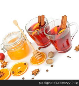 Mulled wine, honey, fruit orange and spices isolated on white background.