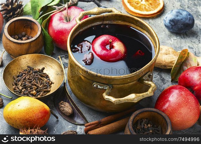 Mulled wine in a stylish bowl.Mulled wine with autumn fruits. Mulled wine in rustic bowl