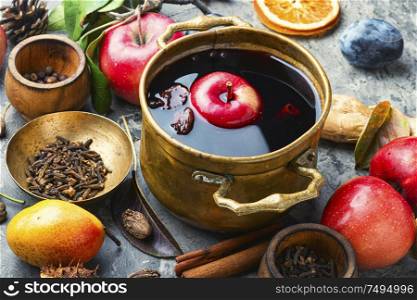Mulled wine in a stylish bowl.Mulled wine with autumn fruits. Mulled wine in rustic bowl