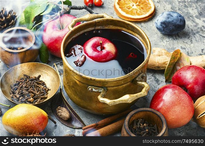 Mulled wine in a stylish bowl.Mulled wine with autumn fruits. Warm mulled wine