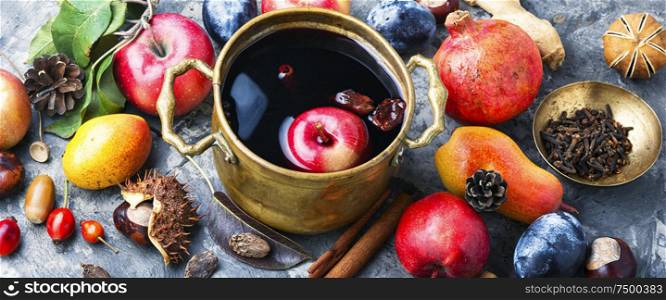 Mulled wine in a stylish bowl.Mulled wine with autumn fruits. Warm mulled wine