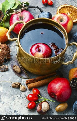 Mulled wine in a stylish bowl.Warm autumn alcoholic drink. Mulled wine in rustic bowl