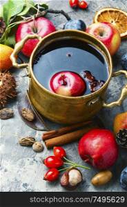Mulled wine in a stylish bowl.Warm autumn alcoholic drink. Mulled wine in rustic bowl