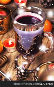 mulled wine in stylish glass. Christmas mulled wine with an orange slice in wineglass
