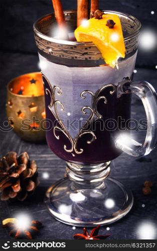 mulled wine in stylish glass. Christmas mulled wine with an orange slice in wineglass