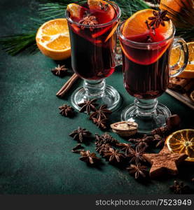 Mulled wine ingredients on dark background. Hot red punch. Christmas drink. Vintage style toned picture