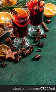Mulled wine ingredients on dark background. Hot red punch with fruits and spices