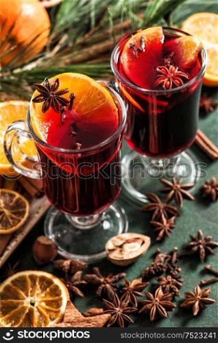 Mulled wine ingredients on dark background. Hot red winter punch with fruits and spices