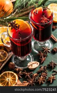 Mulled wine ingredients on dark background. Hot red winter punch with fruits and spices