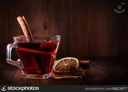 Mulled wine. Mulled wine and spices on wooden background