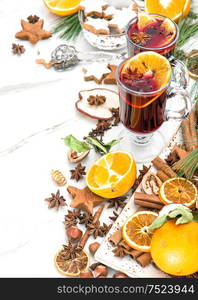 Mulled wine on white background. Hot red punch with fruit and spices. Christmas table decoration