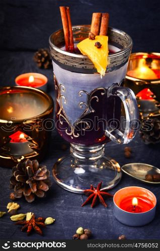 Mulled wine with spices. Christmas mulled wine with an orange slice in a stylish glass