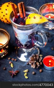 Mulled wine with spices. Christmas mulled wine with an orange slice in a stylish glass