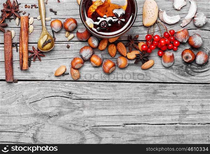 Mulled wine with spices. Glass of mulled wine and spice rack for beverage.Copy space