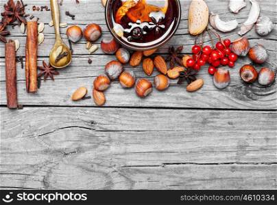 Mulled wine with spices. Glass of mulled wine and spice rack for beverage.Copy space