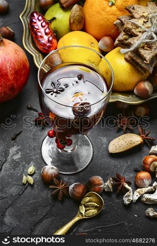 mulled wine with spices. glass of mulled wine with spices on dark concrete background