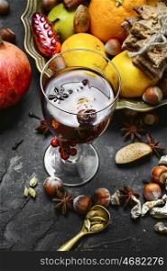 mulled wine with spices. glass of mulled wine with spices on dark concrete background