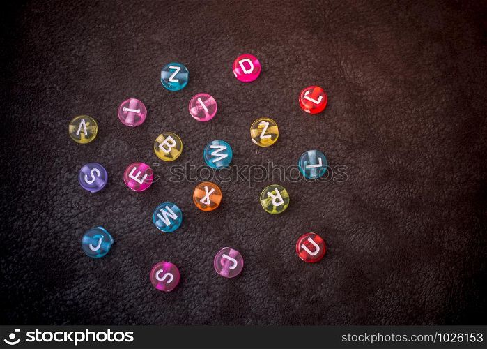 Multi color alphabet letter beads scattered randomly