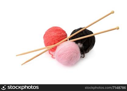 Multi-colored balls and knitting needles isolated on a white background.