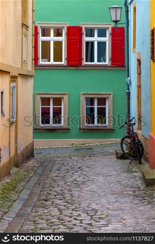Multi-colored facades of houses on an old narrow street. Bamberg. Bavaria Germany.. Bamberg. Old narrow street in the historical part of the city.