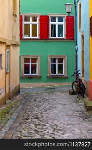 Multi-colored facades of houses on an old narrow street. Bamberg. Bavaria Germany.. Bamberg. Old narrow street in the historical part of the city.