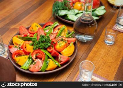 Multi-colored fresh cutted vegetables. Multi-colored fresh cutted vegetables on a wooden plate