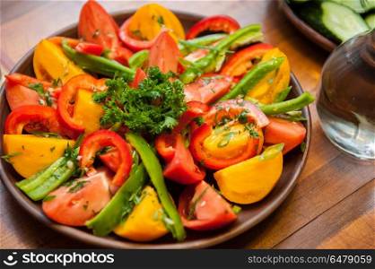 Multi-colored fresh cutted vegetables. Multi-colored fresh cutted vegetables on a wooden plate