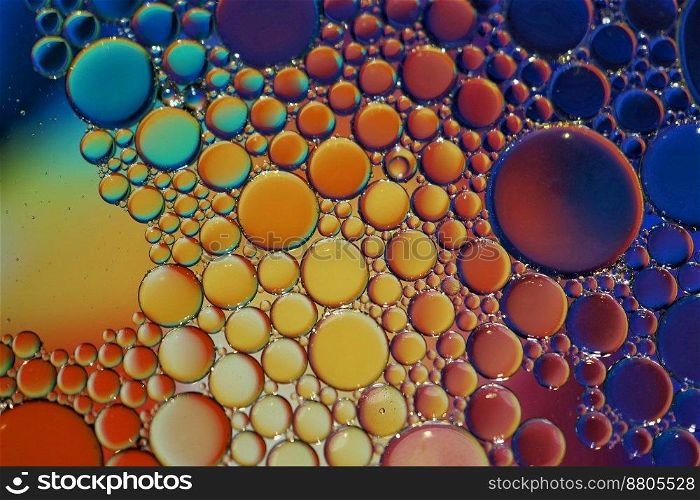 multi colored oil circles on the water, colorful abstract background