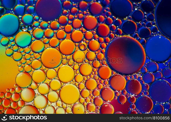 multi colored oil circles on the water, colorful background