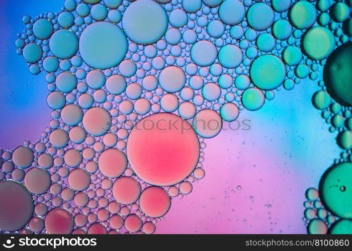 multi colored oil circles on the water, colorful background